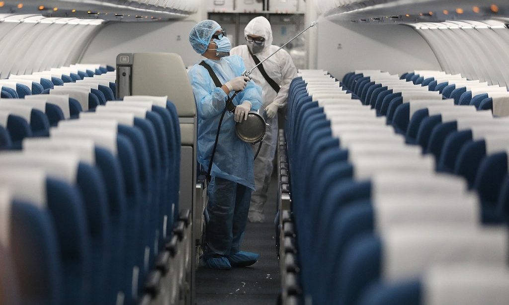 Sanitisation specialists disinfect airplane before passengers enter